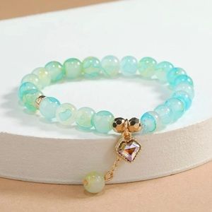 Here we have beautiful different colored charm beaded bracelets .